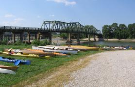 Canoes and kayaks lining the river.